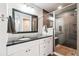 Bathroom featuring granite countertops, modern shower, and neutral tile flooring at 4900 Beverly Dr, Berthoud, CO 80513