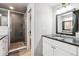 Bathroom featuring granite countertops, modern shower, and neutral tile flooring at 4900 Beverly Dr, Berthoud, CO 80513