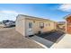 Tan exterior with gravel landscaping and a white door with decorative window and white trim around the window at 4900 Beverly Dr, Berthoud, CO 80513