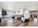 A living room features wood laminate flooring, a large sectional sofa, and a television at 4900 Beverly Dr, Berthoud, CO 80513