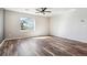 Bright, spacious living room with wood-look floors, large window, and neutral walls at 4900 Beverly Dr, Berthoud, CO 80513