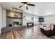 A living room features a fireplace with decorative mantel, ceiling fan, and wood laminate flooring at 4900 Beverly Dr, Berthoud, CO 80513