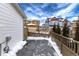 Side yard with snow and wooden fence at 3319 Emily St, Castle Rock, CO 80109