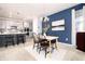 Kitchen dining area with a light wood table, gray kitchen cabinets, and blue walls at 3319 Emily St, Castle Rock, CO 80109