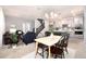 Bright dining area with a light wood table and gray kitchen cabinets at 3319 Emily St, Castle Rock, CO 80109