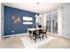 Bright dining room with a wooden table and chairs, adjacent to sliding glass doors at 3319 Emily St, Castle Rock, CO 80109