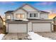 Two-story house with three-car garage at dusk at 3319 Emily St, Castle Rock, CO 80109