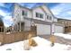 Two-story house with three-car garage and snowy driveway at 3319 Emily St, Castle Rock, CO 80109