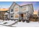 Two-story house with white siding, a gray front door, and a snowy front yard at 3319 Emily St, Castle Rock, CO 80109