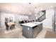 Modern kitchen with gray island, white countertops, and stainless steel appliances at 3319 Emily St, Castle Rock, CO 80109