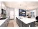 Spacious kitchen island, stainless steel appliances, and a view into the dining area at 3319 Emily St, Castle Rock, CO 80109