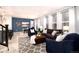 Spacious living room with dark blue walls, a brown sofa, and patterned rug at 3319 Emily St, Castle Rock, CO 80109