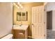 Bathroom featuring vanity with decorative mirror and a door leading to the bedroom at 17224 Lark Water Ln # D, Parker, CO 80134