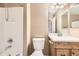 Bathroom featuring a shower-tub combo and vanity with a wood cabinet at 17224 Lark Water Ln # D, Parker, CO 80134