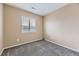 This bedroom features neutral walls, plush gray carpet and a window with blinds at 17224 Lark Water Ln # D, Parker, CO 80134
