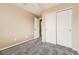 Bedroom with neutral walls, carpet, and large closet space at 17224 Lark Water Ln # D, Parker, CO 80134