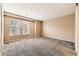 Bedroom featuring neutral carpet, base trim, and natural light from a window at 17224 Lark Water Ln # D, Parker, CO 80134