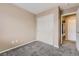 Cozy bedroom featuring neutral walls, plush gray carpet, and a closet with sliding doors at 17224 Lark Water Ln # D, Parker, CO 80134
