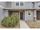Townhome entrance with covered porch and well-kept landscaping at 17224 Lark Water Ln # D, Parker, CO 80134