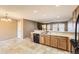 Open concept kitchen with tile floors, wooden cabinets and breakfast bar at 17224 Lark Water Ln # D, Parker, CO 80134