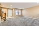 Inviting living room with staircase and large windows at 17224 Lark Water Ln # D, Parker, CO 80134