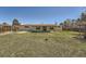 Wide backyard with a covered patio, grass, and a fence at 6923 S Albion St, Centennial, CO 80122
