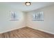 Cozy bedroom featuring hardwood floors, two windows with blinds, and neutral paint at 6923 S Albion St, Centennial, CO 80122