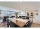 Open dining area with a long wooden table, seating for six, and a seamless view into the kitchen and living room at 6923 S Albion St, Centennial, CO 80122