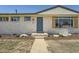 Charming brick home with a gray front door, stylish shutters, and neatly landscaped yard at 6923 S Albion St, Centennial, CO 80122