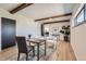 Bright office space with wood-beam ceilings, modern furniture, and a view into a dining area at 6923 S Albion St, Centennial, CO 80122