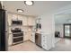 Updated kitchen features white cabinets, stainless steel appliances, subway tile backsplash, and sleek countertops at 6923 S Albion St, Centennial, CO 80122