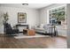 Bright living room featuring hardwood floors, modern furniture, and a large window with a neighborhood view at 6923 S Albion St, Centennial, CO 80122