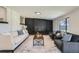 Cozy living room with a black brick fireplace, comfortable seating, and natural light at 6923 S Albion St, Centennial, CO 80122