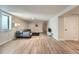 Spacious basement living room with light wood flooring and comfortable seating area at 6923 S Albion St, Centennial, CO 80122