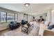 Open living room area with hardwood floors, contemporary furniture, and a large window for plenty of light at 6923 S Albion St, Centennial, CO 80122