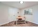 Bright office space with a light wood desk, chair, and window with blinds at 6923 S Albion St, Centennial, CO 80122