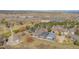 Aerial view of neighborhood with lush trees, walking paths, and water feature at 1950 Five Iron Dr, Castle Rock, CO 80104