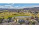 Aerial view overlooking a golf course community with clubhouse and pond at 1950 Five Iron Dr, Castle Rock, CO 80104