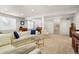 Spacious finished basement featuring neutral carpet, a sofa, and a stairway to upper floors at 1950 Five Iron Dr, Castle Rock, CO 80104