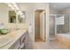Bright bathroom featuring double sinks, vanity lighting, a separate shower, and a soaking tub at 1950 Five Iron Dr, Castle Rock, CO 80104