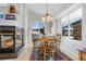 Cozy dining area with fireplace, wood table, and scenic views at 1950 Five Iron Dr, Castle Rock, CO 80104