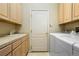 Functional laundry room with cabinets, sink, and modern washer and dryer at 1950 Five Iron Dr, Castle Rock, CO 80104