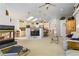 Open living space with a fireplace, kitchen island, and vaulted ceilings at 1950 Five Iron Dr, Castle Rock, CO 80104