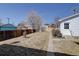 Backyard features a grass lawn, a wood fence, and a detached garage at 525 W Midway Blvd, Broomfield, CO 80020