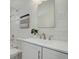 Bright bathroom featuring a white sink, modern faucet, tiled walls, and decorative accents at 525 W Midway Blvd, Broomfield, CO 80020