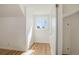 A bedroom with light wood floors, white walls, and a window provides natural light at 525 W Midway Blvd, Broomfield, CO 80020