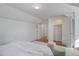 A minimalist bedroom featuring hardwood floors, a ceiling light, and open doors at 525 W Midway Blvd, Broomfield, CO 80020