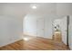 A minimalist bedroom with hardwood floors and white walls has a neutral color scheme at 525 W Midway Blvd, Broomfield, CO 80020