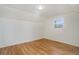 Bedroom featuring hardwood floors, white walls, natural light, and overhead lighting at 525 W Midway Blvd, Broomfield, CO 80020