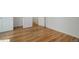 Light hardwood flooring in a bedroom with three doors and white walls at 525 W Midway Blvd, Broomfield, CO 80020